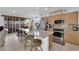 Open kitchen with stainless steel appliances, granite countertops, and a large island with seating at 1909 Pinsky Ln, North Las Vegas, NV 89032