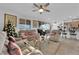 Cozy living room with kitchen in background, with ceiling fan and natural light at 1909 Pinsky Ln, North Las Vegas, NV 89032