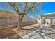 This backyard features a mature shade tree, covered patio, and block wall at 1945 Margarita Ave, Henderson, NV 89011