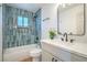 Stylish bathroom showcasing blue tiled walls, tub, and modern vanity with quartz countertop at 1945 Margarita Ave, Henderson, NV 89011