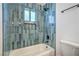 This bathtub features stylish blue tile work, modern fixtures, and a convenient niche for toiletries at 1945 Margarita Ave, Henderson, NV 89011
