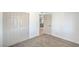 Bedroom featuring a closet with white doors, soft carpet, and a view into the kitchen at 1945 Margarita Ave, Henderson, NV 89011