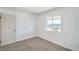 Bright bedroom with fresh white paint, new carpet, and a view through a window at 1945 Margarita Ave, Henderson, NV 89011