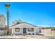 Inviting home features a well-maintained yard, driveway and vibrant blue door at 1945 Margarita Ave, Henderson, NV 89011