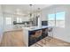 Bright kitchen features white cabinets, modern appliances, and an island with bar seating at 1945 Margarita Ave, Henderson, NV 89011