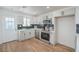 Clean kitchen featuring white cabinetry, stainless steel appliances, and plenty of natural light at 1945 Margarita Ave, Henderson, NV 89011