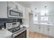 Bright kitchen boasts stainless steel appliances, black backsplash, and white countertops at 1945 Margarita Ave, Henderson, NV 89011