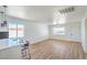 Bright, open living room with wood-look floors, white walls, and a modern ceiling fan at 1945 Margarita Ave, Henderson, NV 89011