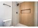 This modern bathroom shower features stylish tile work, rain head, and a built-in niche for toiletries at 1945 Margarita Ave, Henderson, NV 89011