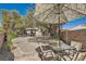 The private backyard is perfect for outdoor dining with a brick patio and mature trees providing shade at 2021 Evansdale St, Henderson, NV 89052