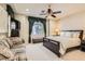 Comfortable bedroom with a ceiling fan, window views, and a loveseat at 2021 Evansdale St, Henderson, NV 89052