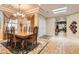 Bright dining room with a skylight, chandelier, and a classic wooden dining table set for a meal at 2021 Evansdale St, Henderson, NV 89052