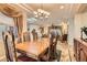 Classic dining room with a chandelier, wood furniture, and an open view to the living area at 2021 Evansdale St, Henderson, NV 89052