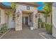 Inviting home entrance with stone pillars, decorative lighting, and a welcoming double-door entryway at 2021 Evansdale St, Henderson, NV 89052