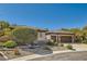 Charming desert home with well-maintained landscaping, stone accents and spacious driveway leading to the garage at 2021 Evansdale St, Henderson, NV 89052