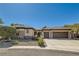 Charming single-story home featuring desert landscaping, stone accents, and a spacious three-car garage at 2021 Evansdale St, Henderson, NV 89052