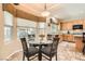 Bright kitchen and breakfast nook featuring a glass table, bay window, and stylish window treatments at 2021 Evansdale St, Henderson, NV 89052
