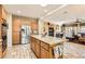 Open kitchen with stainless steel appliances, center island, and seamless transition to living area at 2021 Evansdale St, Henderson, NV 89052