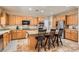 Well-lit kitchen with stainless steel appliances, granite countertops, and a center island with seating at 2021 Evansdale St, Henderson, NV 89052