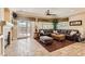 Comfortable living room with a fireplace, large windows, and access to the backyard through sliding doors at 2021 Evansdale St, Henderson, NV 89052