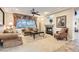 Comfortable living room with a fireplace, soft lighting, and plush sofas perfect for relaxation at 2021 Evansdale St, Henderson, NV 89052