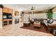 Inviting living room featuring a fireplace, built-in cabinets, a large window, and leather furniture at 2021 Evansdale St, Henderson, NV 89052