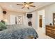Relax in this main bedroom featuring a ceiling fan, TV, and convenient access to the bathroom and walk-in closet at 2021 Evansdale St, Henderson, NV 89052