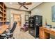 Cozy home office features built-in shelving, a ceiling fan, and a secure Liberty safe at 2021 Evansdale St, Henderson, NV 89052