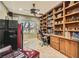 Well-appointed home office with custom built-in bookshelves, desk, and a comfortable seating area at 2021 Evansdale St, Henderson, NV 89052