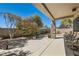Covered patio featuring stylish furniture and meticulously maintained landscaping around a walled-in yard at 2021 Evansdale St, Henderson, NV 89052