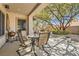 Cozy backyard patio with comfortable seating and a barbecue grill under the shade of a mature tree at 2021 Evansdale St, Henderson, NV 89052
