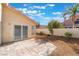 Spacious backyard featuring a tiled patio, desert landscaping, and a secure privacy fence at 2124 Brighton Shore St, Las Vegas, NV 89128