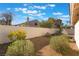 Landscaped backyard with desert plants and privacy wall with a tiled patio area at 2124 Brighton Shore St, Las Vegas, NV 89128