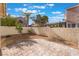 Backyard features desert landscaping, privacy fencing, and a tiled patio area at 2124 Brighton Shore St, Las Vegas, NV 89128