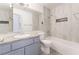 Modern bathroom with single sink vanity, tub, and tiled shower with shower head at 2124 Brighton Shore St, Las Vegas, NV 89128