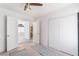 Bright bedroom features a ceiling fan, closet, and opens to a view of the connected room at 2124 Brighton Shore St, Las Vegas, NV 89128