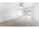 Bright, spacious bedroom features a ceiling fan and sliding door access to the outdoor patio at 2124 Brighton Shore St, Las Vegas, NV 89128