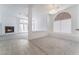 A dining room featuring tiled floors, an arched window, and views of the living room at 2124 Brighton Shore St, Las Vegas, NV 89128