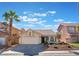 Charming single-story home featuring desert landscaping, a tile roof and an attached two-car garage at 2124 Brighton Shore St, Las Vegas, NV 89128