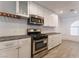 A modern kitchen featuring white cabinets, stainless steel appliances, and gray countertops at 2124 Brighton Shore St, Las Vegas, NV 89128