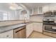 A modern kitchen featuring white cabinets, stainless steel appliances, and gray countertops at 2124 Brighton Shore St, Las Vegas, NV 89128