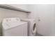 Laundry room with white washer, dryer, and access door at 2124 Brighton Shore St, Las Vegas, NV 89128