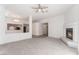 An open living room featuring a fireplace, plush carpeting, and views of the kitchen at 2124 Brighton Shore St, Las Vegas, NV 89128