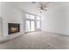 An open living room featuring a fireplace, plush carpeting, and double doors with an abundance of natural light at 2124 Brighton Shore St, Las Vegas, NV 89128
