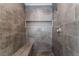 A modern tiled shower features a built-in bench and convenient niche for storage at 2124 Brighton Shore St, Las Vegas, NV 89128