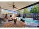 A covered outdoor living space, complete with a pool, spa, fireplace, and ceiling fan at 2132 Ponticino St, Henderson, NV 89044