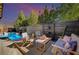 Relaxing backyard featuring a swimming pool, wooden fence, and outdoor seating at 2132 Ponticino St, Henderson, NV 89044