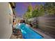 Backyard with a long swimming pool, privacy fence, and patio at 2132 Ponticino St, Henderson, NV 89044