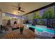 Outdoor living area with cozy fireplace, hot tub and sparkling swimming pool at 2132 Ponticino St, Henderson, NV 89044