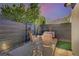 Backyard patio with modern outdoor seating, privacy fence and desert landscaping at 2132 Ponticino St, Henderson, NV 89044